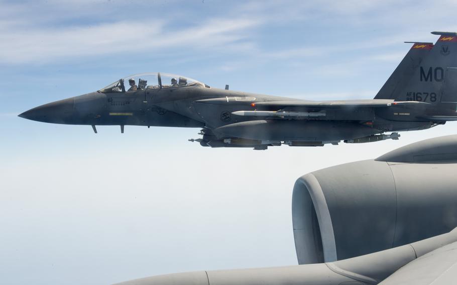 An F-15 fighter flies alongside a KC-135 Stratotanker while supporting air operations against the Islamic State group in Iraq and Syria on March 24, 2016.