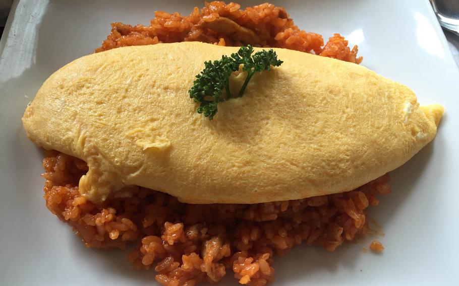 Tampopo omurice, the signature dish at Taimeiken in Nihonbashi, Tokyo, is named after the 1985 food-centered Japanese film "Tampopo." The simple entree is a fluffy three-egg omelet served over a mound of ketchup-fried rice.