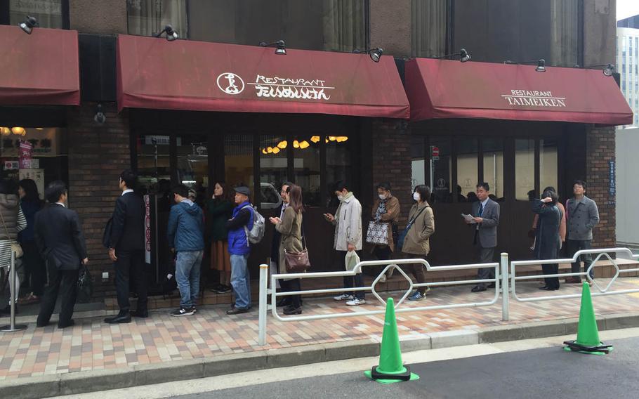 Customers line up outside Taimeiken in Nihonbashi, Tokyo, April 1. The restaurant is famous for its Western-style Japanese cuisine, most notably omurice.