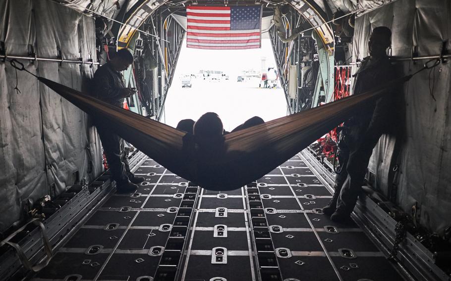 Airmen attached to Yokota Air Base, Japan, take a break inside their C-130 Hercules while waiting to load cargo Tuesday, April 19, 2016 in Chitose, Japan.