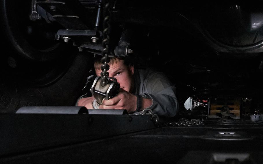 An airman from Yokota Air Base, Japan ties down a military utility vehicle to a U.S. Air Force C-130 Hercules from Yokota Air Base, Japan Tuesday, April 19, 2016 in Chitose, Japan.