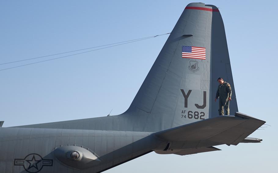 An airman attached to Yokota Air Base performs a preflight inspection of a C-130 Hercules at Yokota Air Base, Japan Tuesday, April 19, 2016.