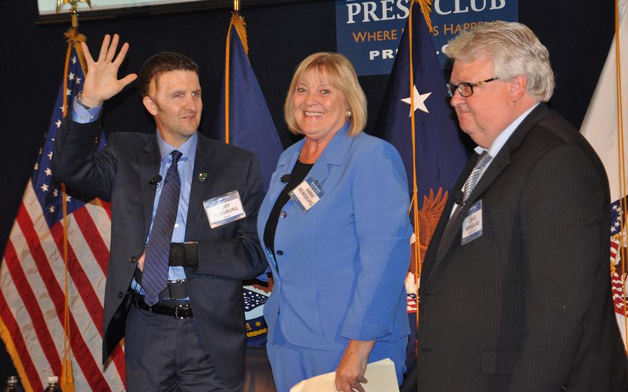 Army Sgt. First class Cory Remsburg, left, along with his parents Annie and Craig, receive a standing ovation during a VA Brain Trust summit in Washington DC. Remsburg was an Army Ranger when he suffered severe injuries, including traumatic brain injury from a bomb in Afghanistan in 2009.