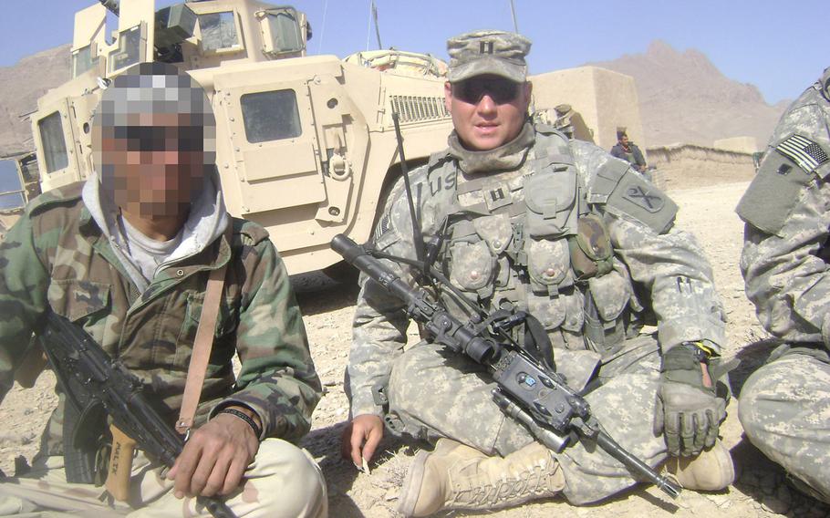 Longtime U.S. military interpreter "Malik," left, on a patrol with American forces in Farah province, Afghanistan, in 2008. Despite working for more than a decade with U.S. troops and facing death threats from the Taliban, Malik has been waiting five years for a visa created specifically for former Afghan and Iraqi interpreters facing danger. 