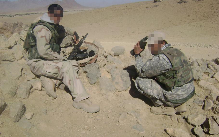 "Malik" and a fellow interpreter on patrol in Herat province in 2007. Thousands of Afghan interpreters who worked for U.S. forces are stuck in limbo while awaiting a Special Immigrant Visa, created to give safe passage to the U.S. for those facing threats for their service to America. 