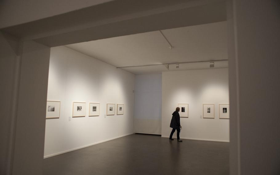 A visitor shares a lone moment with Andre Kertesz's pictures during the opening of an exhibit of the photographer's work at the Pfalzgalerie in Kaiserslautern, Germany. The exhibit runs through June 12.