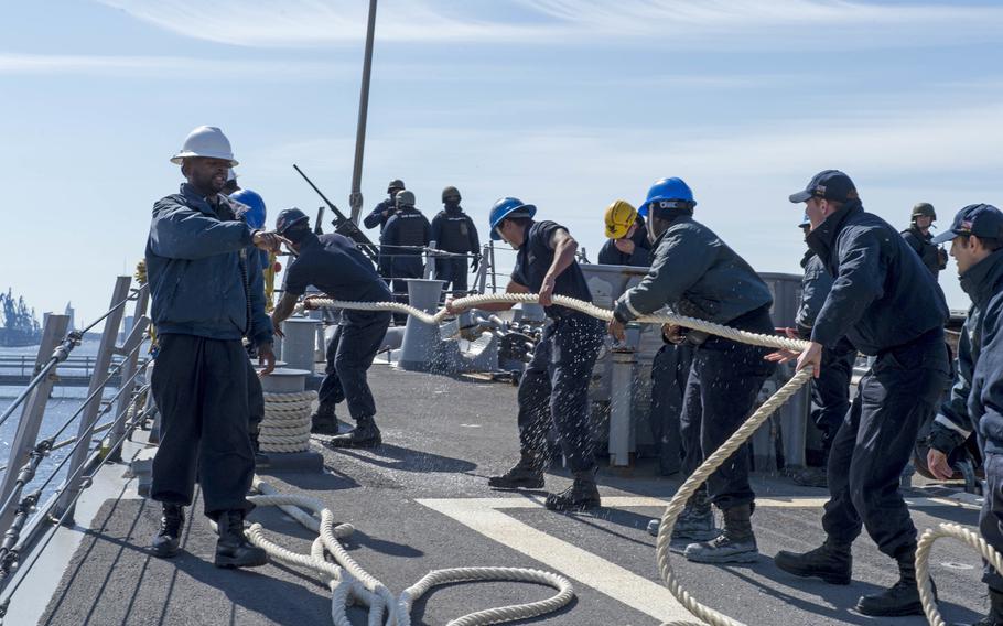 Sailors aboard the USS Donald Cook haul in a mooring line as the ship gets underway from Riga, Latvia,  April 21, 2016.