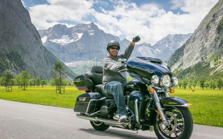 Rumbling Harleys and sport bikes will soon take over the Alpine roads surrounding the Edelweiss Lodge and Resort in Garmisch-Partenkirchen, Germany, with the 10th annual Ride the Alps military motorcycle rally June 24-26. Here, a satisfied rider points the way to scenic views along the organized routes.