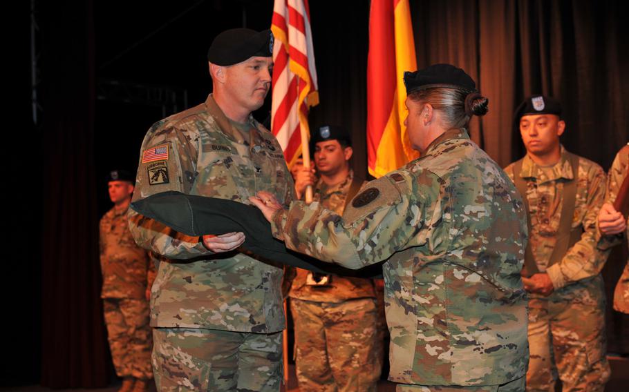 Col. Lawrence Burns, left, and Command Sgt. Maj. Leigh Perry, case the unit colors during the Warrior Transition Battalion-Europe inactivation ceremony May 5, 2016 at Kleber Kaserne in Kaiserslautern, Germany.