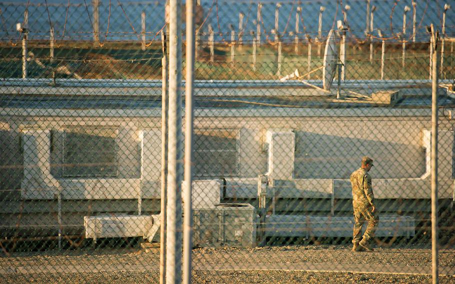 A U.S. Army soldier walks inside Camp Delta, a facility on U.S. Naval Station Guantanamo Bay, Cuba where detainees were once held.