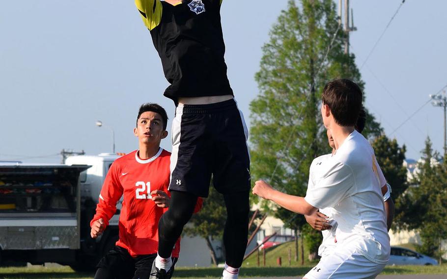Yokota keeper Chris Rickenbach skies for a save against Okinawa Christian during Tuesday's group-play match in the Far East Division II Boys Soccer Tournament, won by the Panthers 2-0.