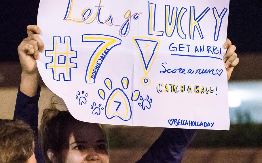 A fan holds up a sign supporting Sophie Yates of Yokota during Wednesday's title game in the Far East Division II Softball Tournament, won by the Panthers 3-2 over Edgren.