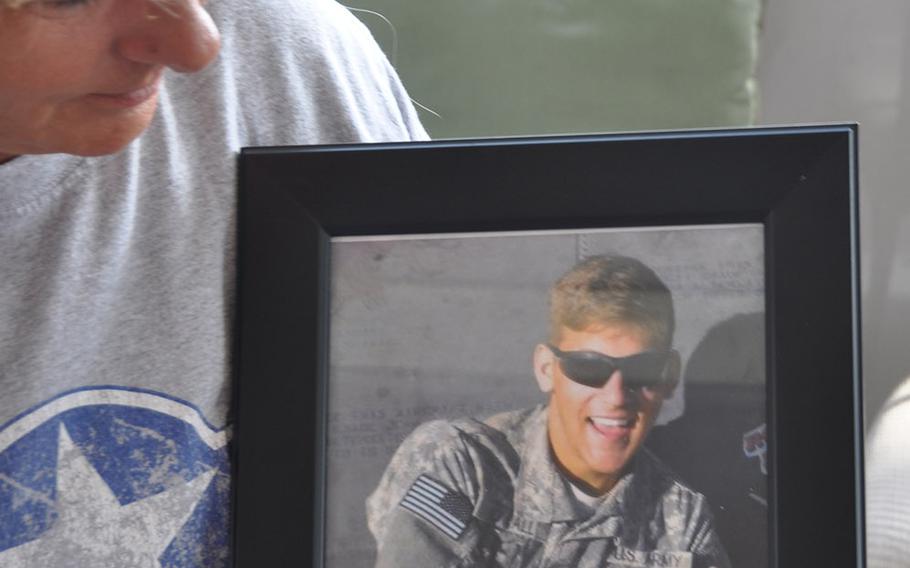 Kelly Kowall, creator of My Warrior's Place in Ruskin Florida, holds a photograph on March 10, 2016 of her son Corey was killed in action in Afghanistan Sept. 20, 2009.