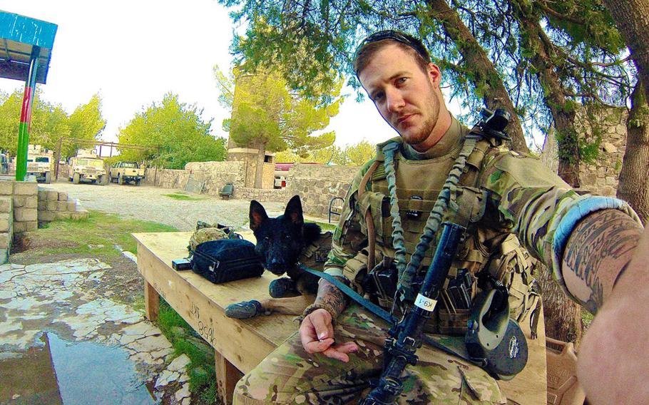 Army Sgt. Wess Brown snaps a selfie of him and his military working dog Isky in Afghanistan. The German shepherd, whose career was ended when he had to have a leg amputated, now serves as Brown's PTSD service dog.