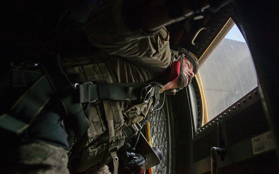 U.S. Air Force Tech. Sgt. Daniel Warren, a pararescueman jumpmaster assigned to the 82nd Expeditionary Rescue Squadron, does checks before a free-fall jump near Camp Lemonnier, Djibouti, on Jan. 9, 2014.