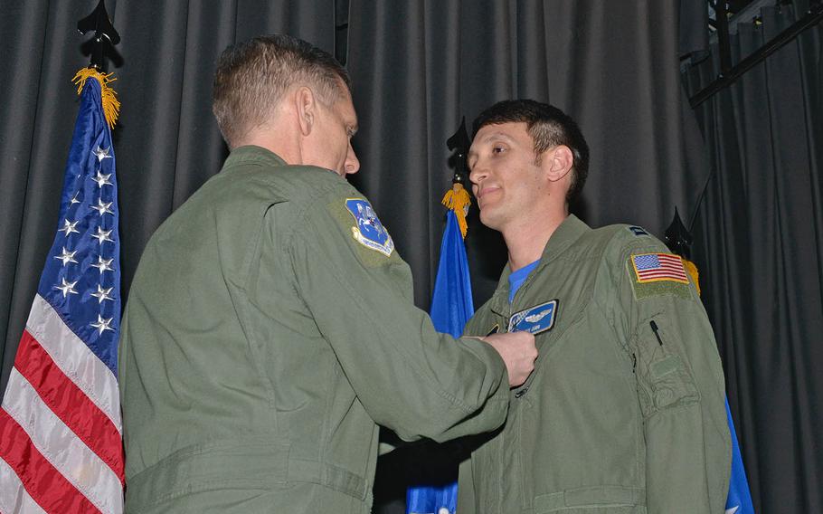 Capt. Kenneth Jubb, 37th Airlift Squadron flight commander, receives the Air Medal from Lt. Gen. Timothy Ray, 3rd Air Force and 17th Expeditionary Air Force commander, on Feb. 19, 2016, at Ramstein Air Base, Germany. Jubb and three others received the award for an emergency ramp-open landing. 