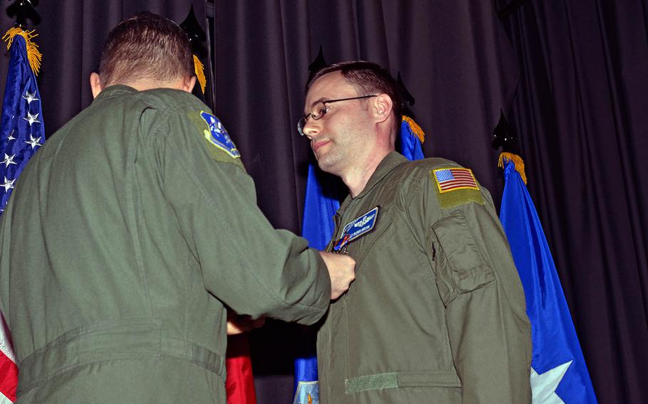 Master Sgt. Boris Brink, 37th Airlift Squadron operations superintendent, receives the Air Medal from Lt. Gen. Timothy Ray on Feb. 19, 2016, at Ramstein Air Base, Germany. Brink and three others earned the medal, which is awarded for single acts of heroism or meritorious service in flight, for actions May 24, 2014. 