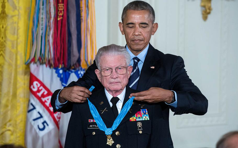 President Barack Obama presents the Medal of Honor to retired U.S. Army Lt. Col. Charles Kettles on July 18, 2016, at the White House. Kettles distinguished himself in combat operations near Duc Pho, Vietnam, on May 15, 1967, and is credited with saving the lives of 40 soldiers and four of his own crew members. 