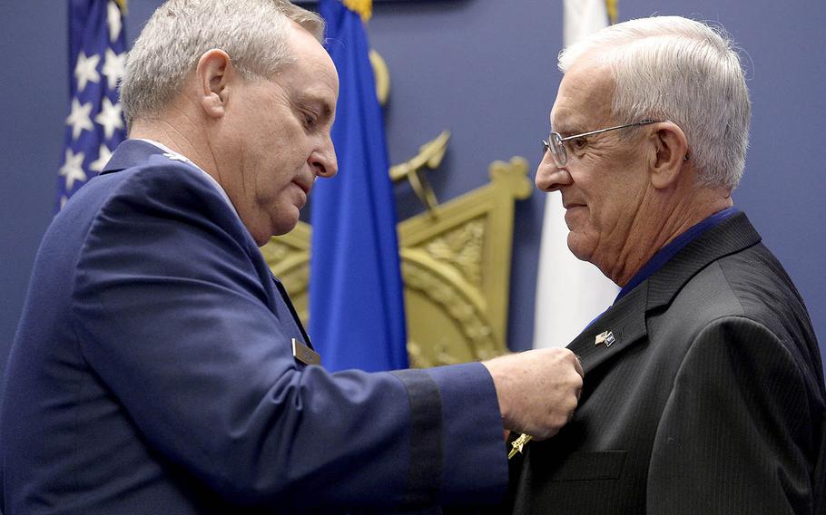 Air Force Chief of Staff Gen. Mark A. Welsh III pins the Silver Star on  retired Chief Master Sgt. Ronald W. Brodeur during a Pentagon ceremony Dec. 17, 2015.  Brodeur received the medal for his gallant action in Vietnam in 1969.