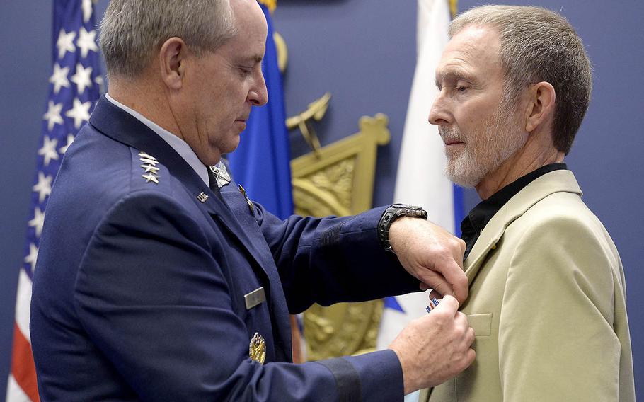 Air Force Chief of Staff Gen. Mark A. Welsh III pins the Silver Star to former Sgt. Eric L. Roberts II during a Pentagon ceremony Dec. 17, 2015.  Roberts received the medal years after the original paperwork was lost.   