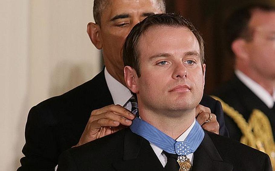 President Barack Obama presents the Medal of Honor to Senior Chief Petty Officer Edward C. Byers Jr. on Feb. 29, 2016, at the White House. Byers, a member of SEAL Team Six, gives credit to his family and SEAL teammates for his service. 
