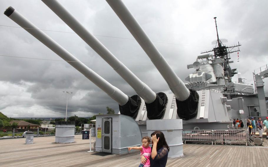 The 16-inch guns aboard the Missouri loom above visitors at the battleship's memorial in Hawaii. For firing, the barrels of the guns would be rotated to shoot over the side of the ship, firing shells up to 20 miles away.