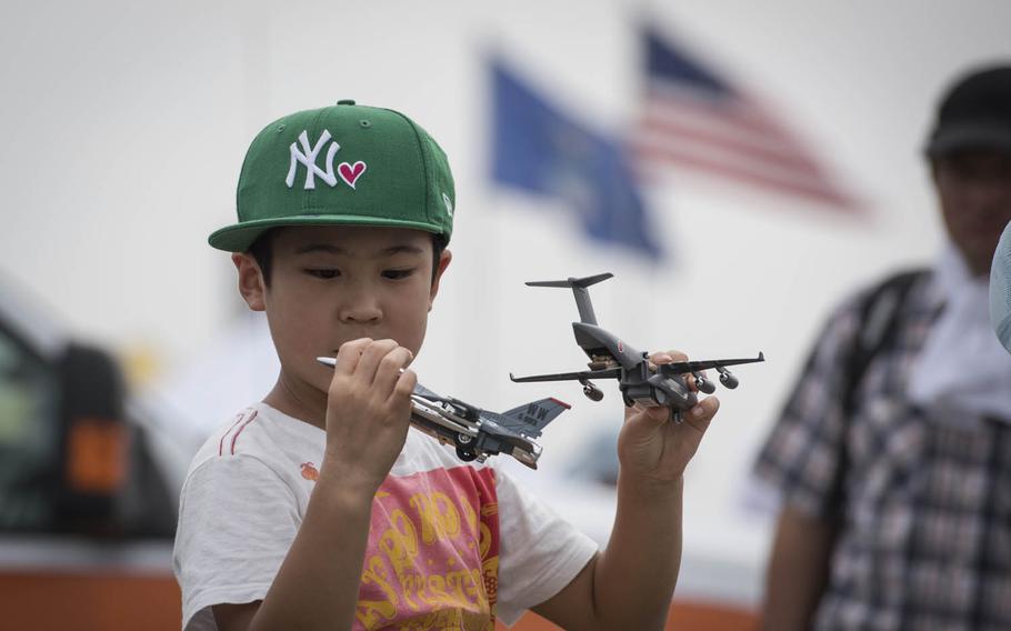 A boy plays with toy aircraft during the 2016 Friendship Festival at Yokota Air Base, Japan, Saturday, Sept. 17, 2016. Tens of thousands of people attend the festival every year to learn more about the U.S. military and American culture.