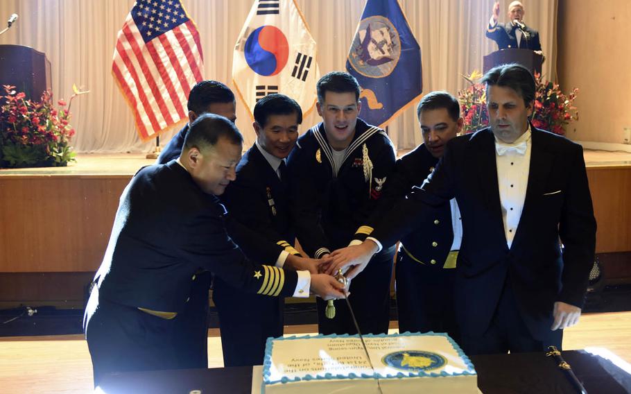 From left to right, Capt. Kwan Lee; Command Master Chief Christopher Stone; South Korean Vice Adm. Lee Ki-sik, commander of the South Korean fleet; Petty Officer 2nd Class Kyle Gambel; Rear Adm. Brad Cooper, commander of Naval Forces Korea; and U.S. Ambassador to South Korea Mark Lippert cut a cake to celebrate the Navy's 241st birthday during the Navy Ball in Busan, South Korea, Friday, Oct. 7, 2016.