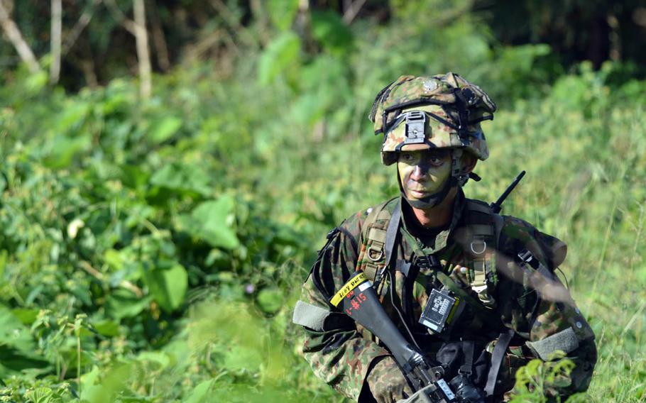 A Japanese fighter pops out of the jungle on Tinian, in the U.S. Commonwealth of the Northern Mariana Islands, Tuesday, Nov. 8, 2016. U.S. servicemembers assisted Japanese troops during a scenario requiring them to retake an island, as part of the bilateral Keen Sword exercise.