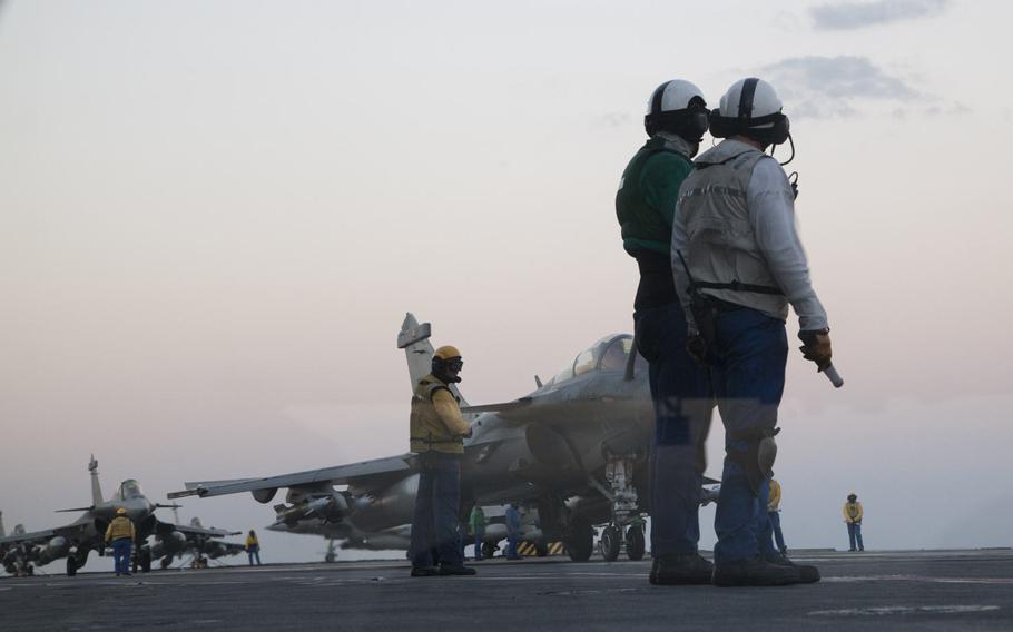 Crew members prepare to launch Dassault Rafale M fighter-bombers off the flight deck of French navy aircraft carrier Charles de Gaulle in the eastern Mediterranean on Nov. 25, 2016.  The jets are bombing Islamic State targets in Iraq and Syria.