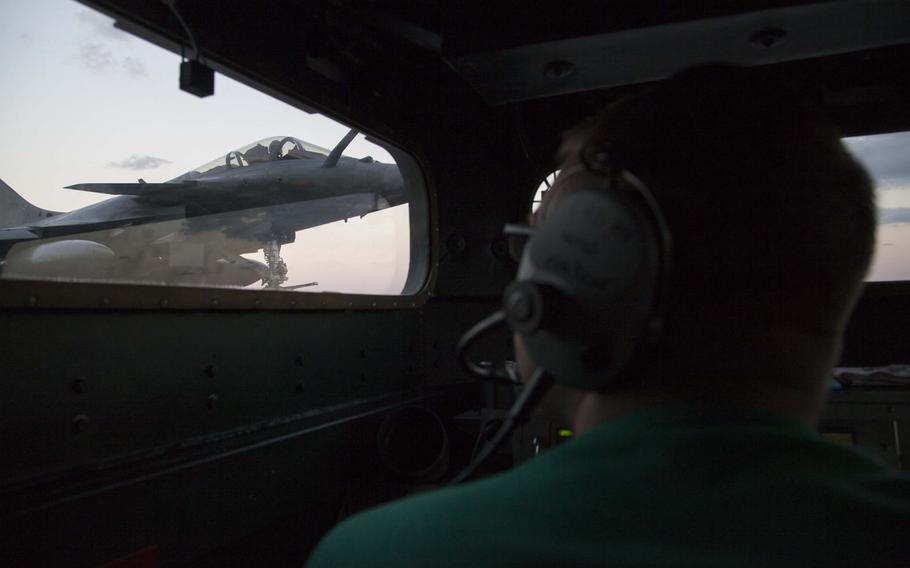 A controller watches from the catapult control station, known as "the bubble," aboard the French navy aircraft carrier Charles de Gaulle as a Rafale M jet moves into launch position on Nov. 25, 2016. The Charles de Gaulle and its air wing are supporting the coalition to defeat the Islamic State in Iraq and Syria.