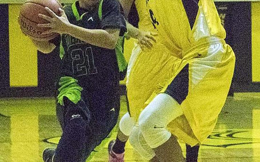 Kubasaki's Dylan Canlas drives against two Kadena defenders during Friday's boys basketball game, won by the two-time defending Far East Division I Tournament champion Dragons 68-62, their first win over the Panthers in four tries this season.