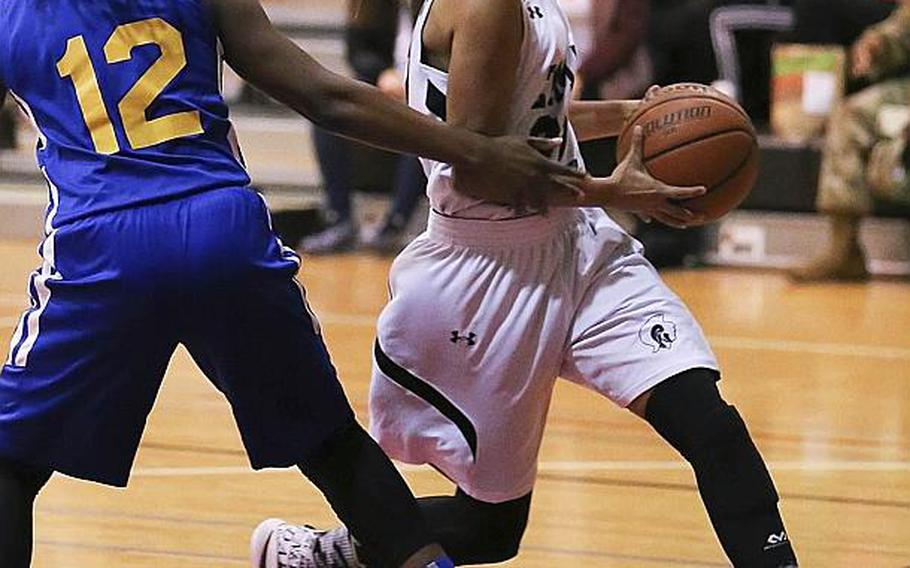 Zama's Ti'Ara Carroll drives past Yokota's Jamia Bailey to the basket during Friday's girls basketball game, won by the Panthers 37-24.
