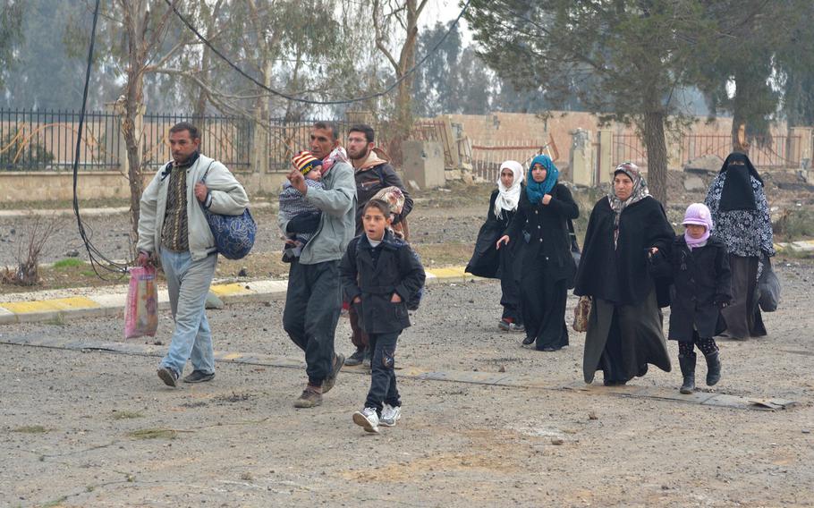 Residents return to Mosul's al-Arabi neighborhood Wednesday, Jan. 25, 2016.