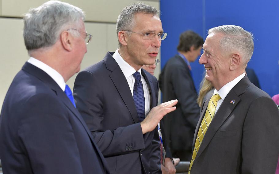 British Defense Minister Michael Fallon, left, talks with NATO Secretary-General Jens Stoltenberg and U.S. Defense Secretary Jim Mattis at NATO headquarters in Brussels on Thursday, Feb. 16, 2017.