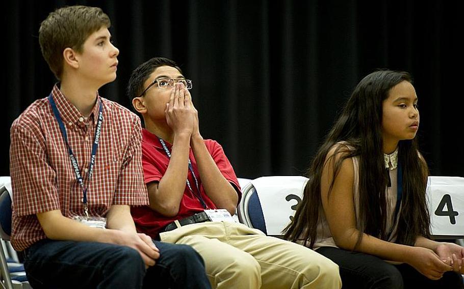 Naples Middle School's Ryan Rayos, center, anxiously listens to a competitor spell a word that could win Rayos the 35th annual European PTA Spelling Bee at Ramstein Air Base, Germany, on Saturday, March 18, 2017. Rayos went on to win in the 19th round.