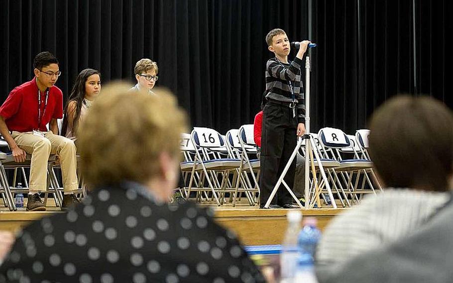 Robert Rasmussen, from Gafenwoehr Elementary School, spells a word for judges during the 35th annual European PTA Spelling Bee at Ramstein Air Base, Germany, on Saturday, March 18, 2017.