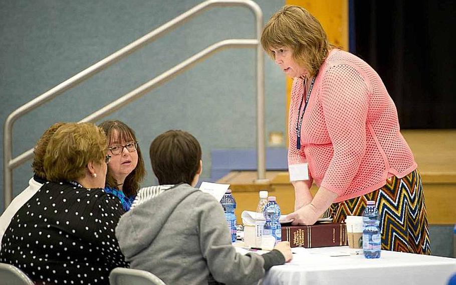 Moderator Sharon Emerling, right, a teacher at Landstuhl Elementary/Middle School, discusses the pronunciation of a word during the 35th annual European PTA Spelling Bee at Ramstein Air Base, Germany, on Saturday, March 18, 2017. Elementary and middle school students from 31 different schools competed in the bee.