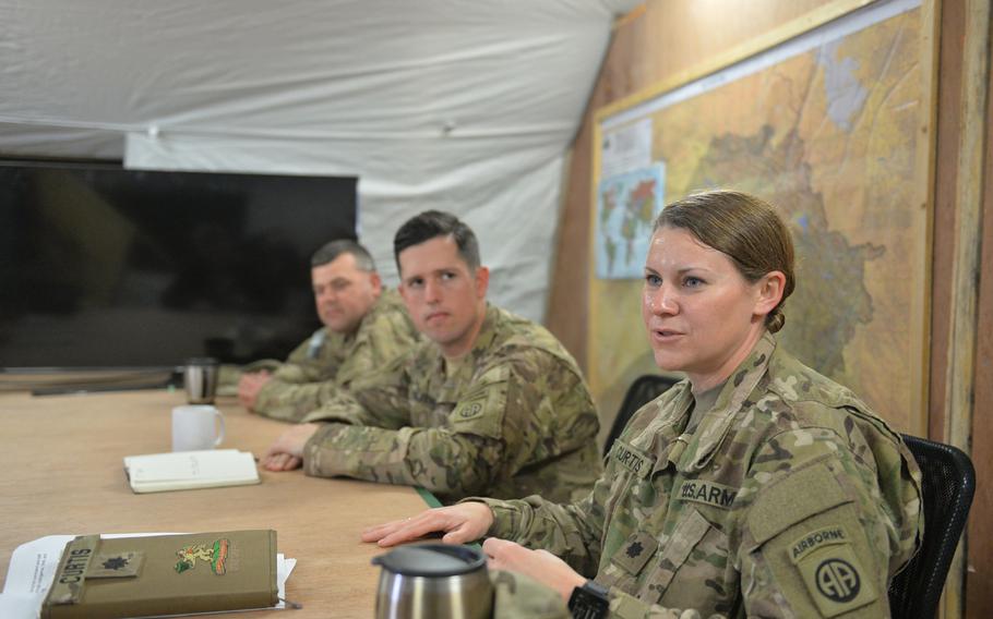 Lt. Col. Elizabeth Curtis discusses efforts to resupply U.S. and Iraqi forces while 1st Sgt. Greg Bristley, left, and Capt. Zach Beecher look on during a press event at Qayara Airfield West on Friday, March 17, 2017.