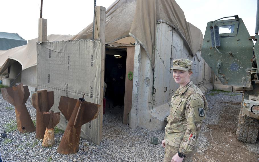 Platoon commander and 1st Lt. Mary Floyd stands near a structure that serves as the living quarters for the soldiers of ''Odin'' battery at Qayara Airfield West, pictured here on Friday, March 17, 2017. Floyd, a field artillery officer, said she loves to fire rockets, but she welcomed Army rules allowing women to serve in cannon batteries now, too.