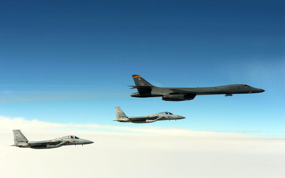 An Air Force B-1B Lancer flies in formation near Japan with Japan Air Self-Defense Force F-15s, Tuesday, March 21, 2017.