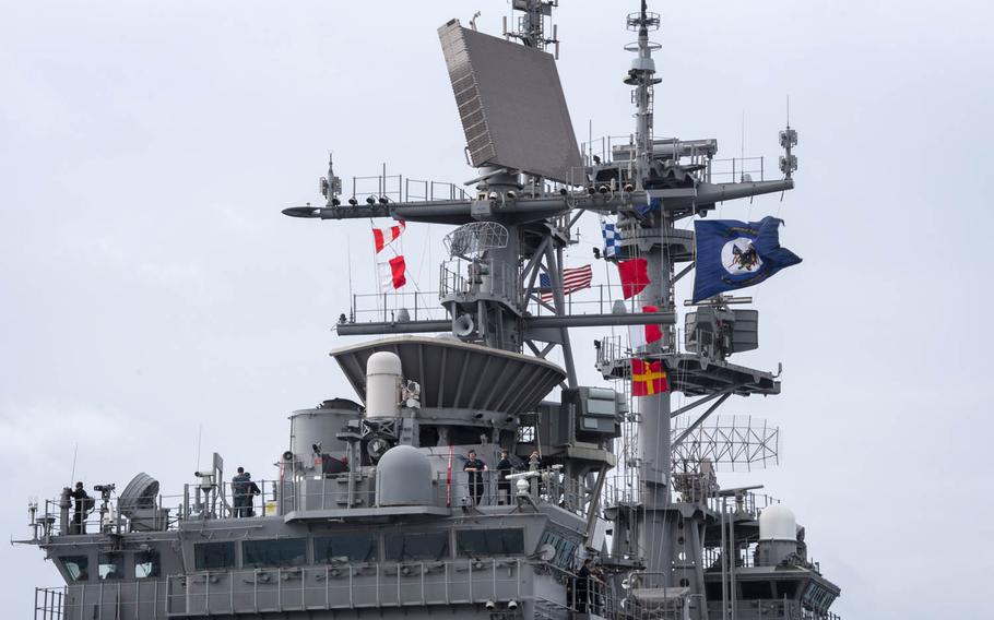 The amphibious assault ship USS Bonhomme Richard flies its colors as it arrives at White Beach Naval Base, Okinawa, Thursday, April 6, 2017.