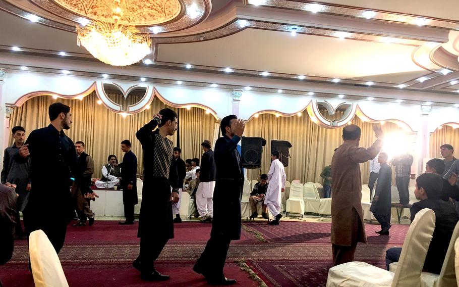 Male dancers celebrate a wedding at Arzo Shahr Wedding Hall in Kabul, Afghanistan, on Nov. 8, 2016.