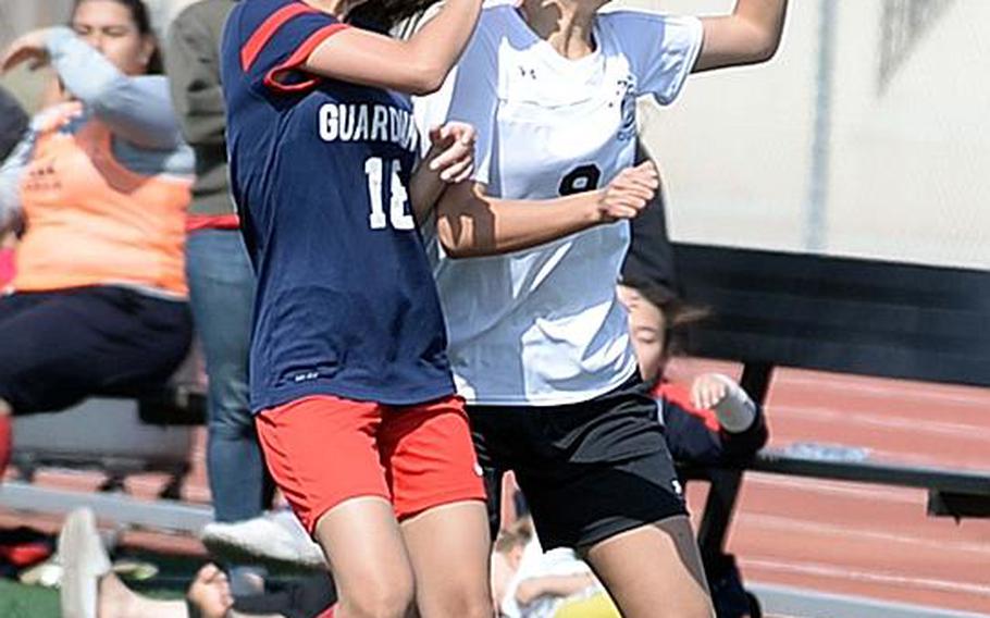 Yongsan's Iris Song and Osan's Madeline Geer try to head the ball during Wednesday's Korea Blue girls soccer semifinal. The Cougars won 3-1 and face Seoul Foreign in Saturday's final.