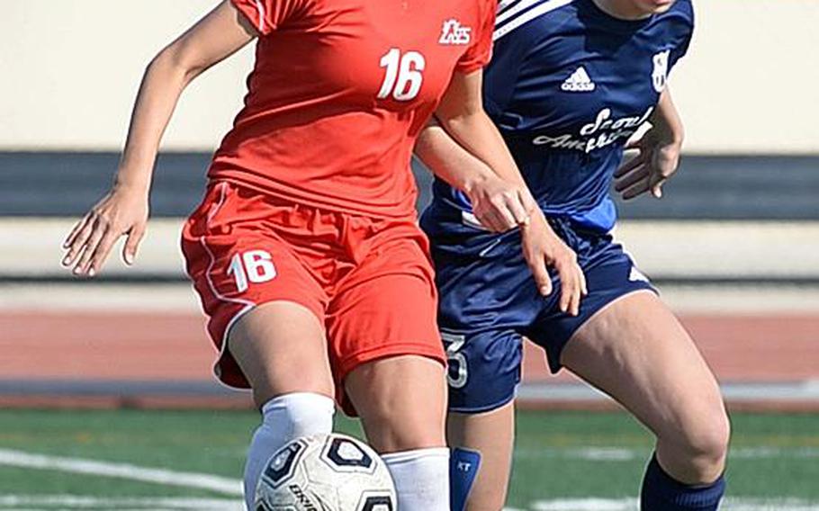 Seoul Foreign's Maria Fernanda de Carvalho dribbles the ball away from Seoul American's MK Dunleavy during Wednesday's Korea Blue girls soccer semifinal. The Crusaders won 2-1 and face Osan in Saturday's final.