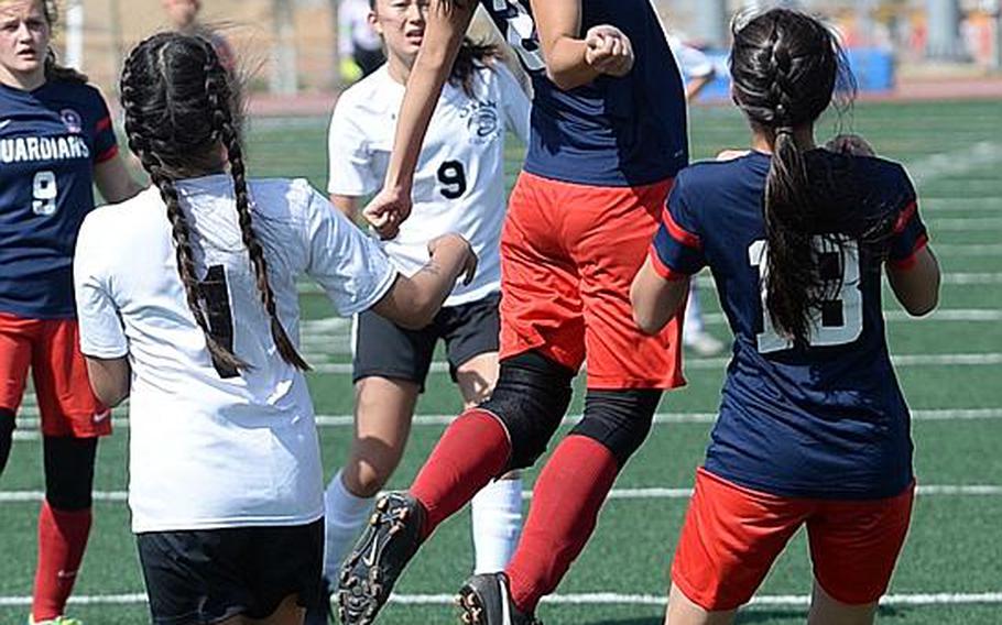 Yongsan's Jenie Nam skies over the pack to play the ball against Osan during Wednesday's Korea Blue girls soccer semifinal. The Cougars won 3-1 and face Seoul Foreign in Saturday's final.