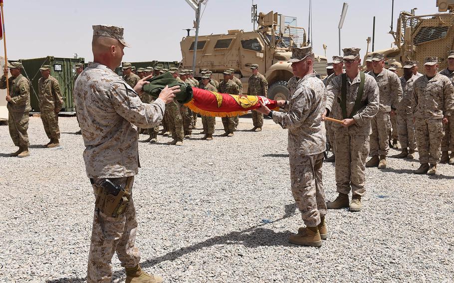 Members of Task Force Southwest prepare to raise the Marine Corps flag at a transfer of authority ceremony at Camp Shorab, Afghanistan, Saturday April 29, 2017. The Marines are taking over the Helmand train-and-advise mission from Task Force Forge, an Army unit (pictured in the background) which has been in Helmand since last year.