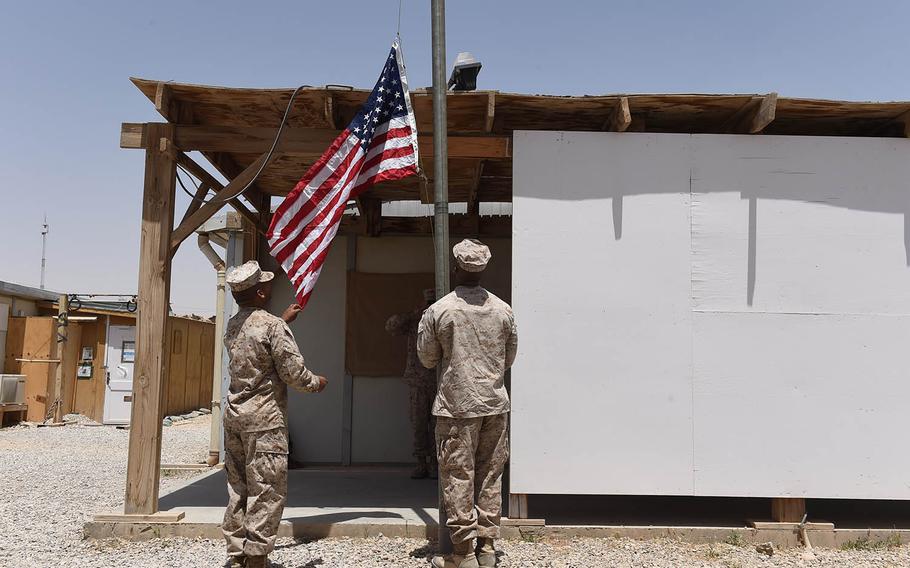Members of Task Force Southwest raised the American flag during a transfer of authority ceremony at Camp Shorab, Afghanistan, Saturday April 29, 2017. The Marines are taking over a train-and-advise mission from Task Force Forge, an Army unit which has been in Helmand since last year.