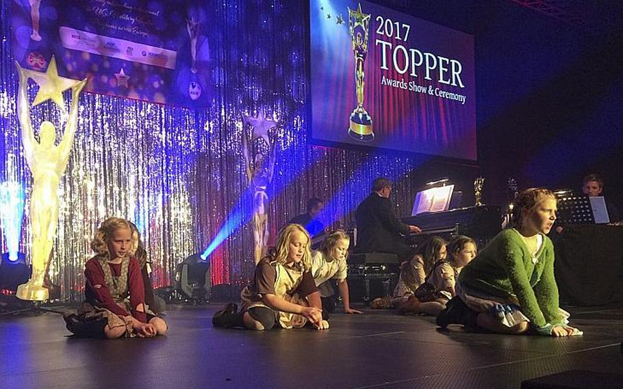 Members of the Wiesbaden Amelia Earhart Playhouse's production of "Annie" preform "It's a Hard Knock Life" at the 2017 TOPPERS awards in Wiesbaden, Germany, Saturday, April 29, 2017.