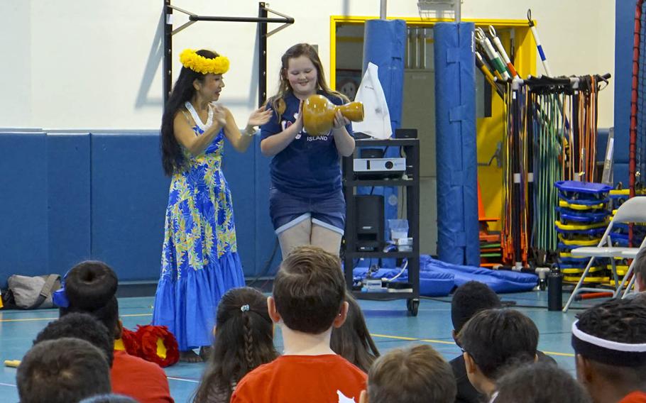 A fifth-grader from Joan K. Mendel Elementary School at Yokota Air Base, Japan, tries her hand at a traditional Polynesian percussion instrument, used to stay in rhythm while dancing, during the school's annual JaPANDAsia festival, Friday, May 5, 2017.